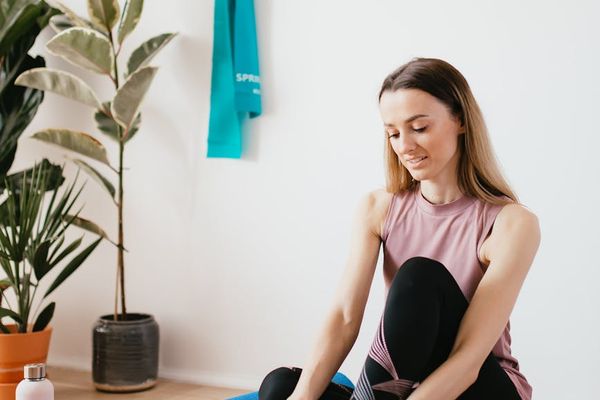 A neatly folded yoga mat and a water bottle.